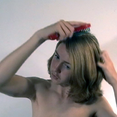 Teenage boy brushing his hair